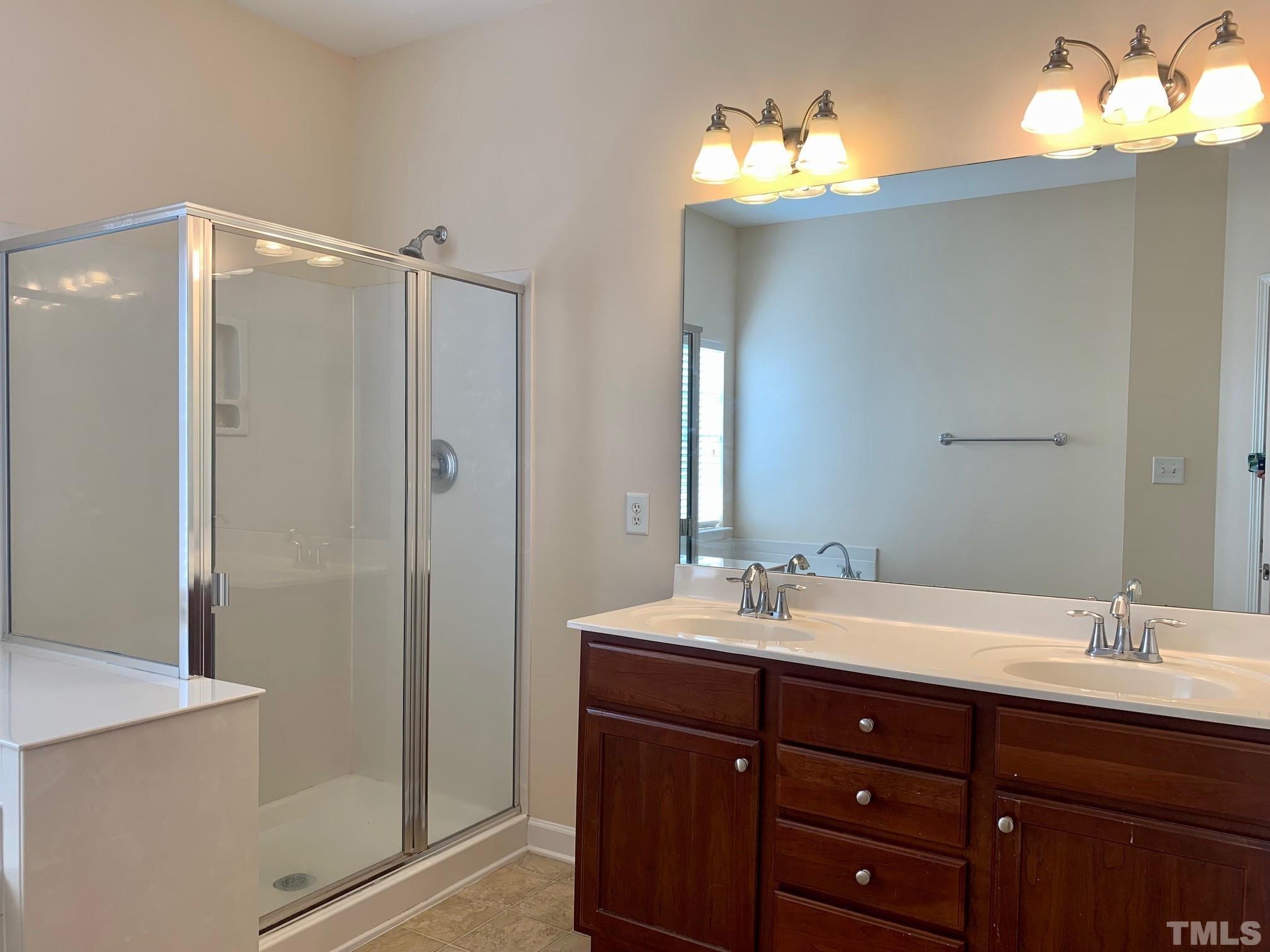 241 Grenoch Valley Lane Apex, NC 27539 - Photo 19 of 27 a bathroom with a sink vanity and a mirror