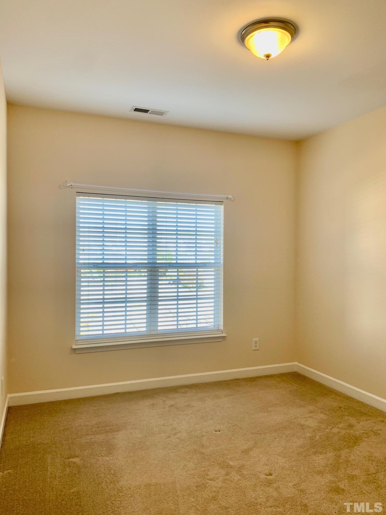 241 Grenoch Valley Lane Apex, NC 27539 - Photo 24 of 27 an empty room with a empty space and a window
