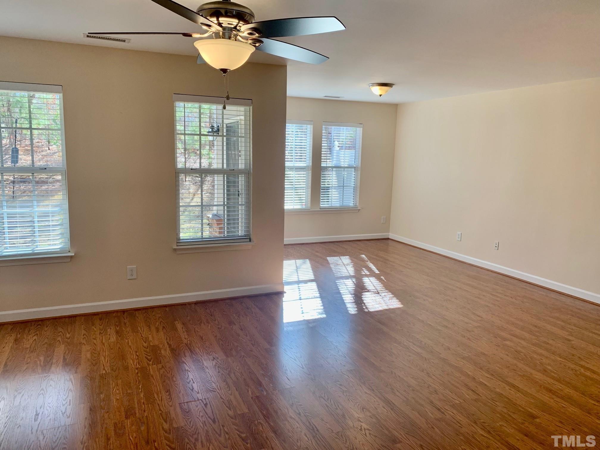 241 Grenoch Valley Lane Apex, NC 27539 - Photo 3 of 27 wooden floor in an empty room with a window