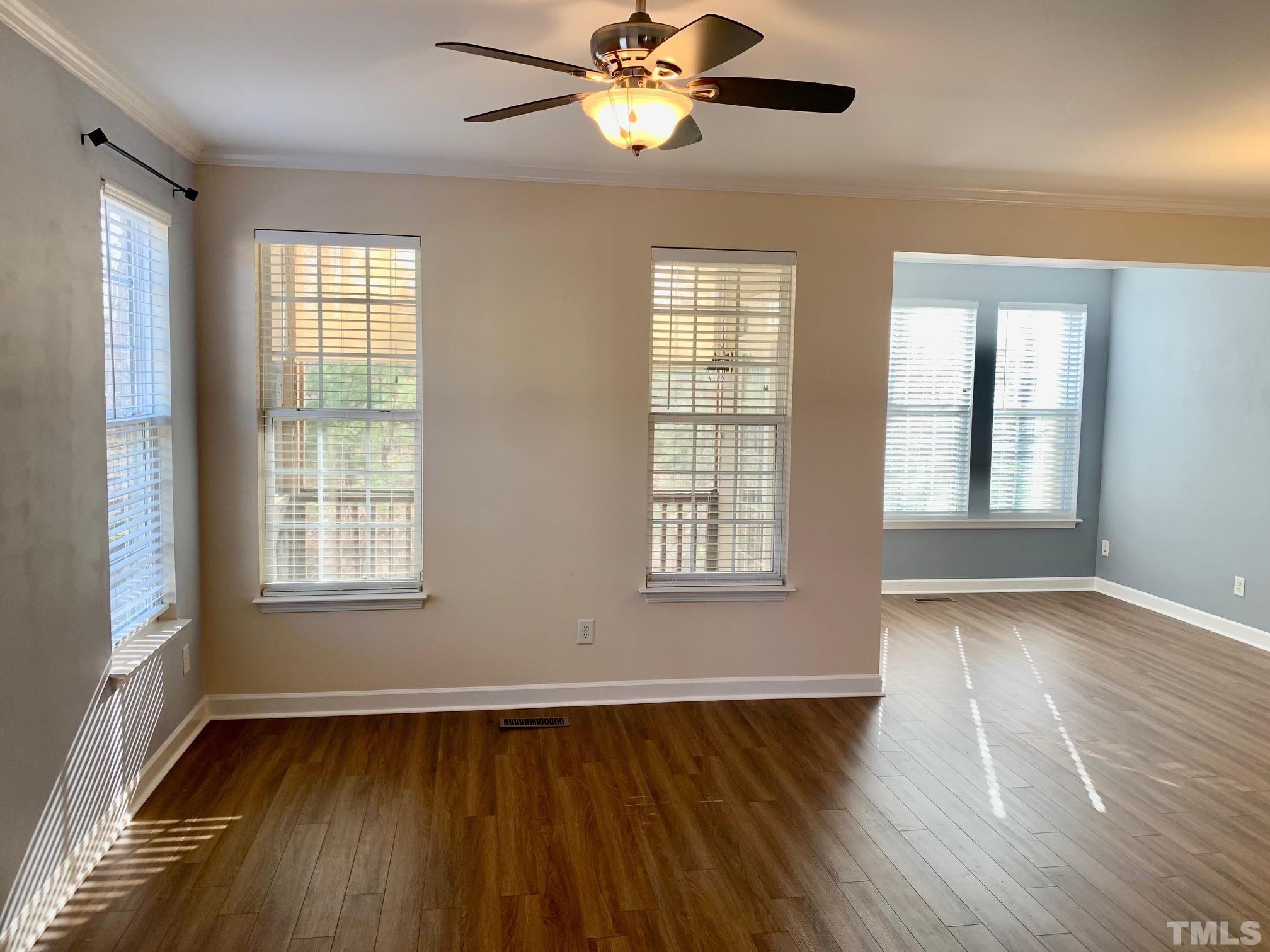 241 Grenoch Valley Lane Apex, NC 27539 - Photo 10 of 27 a view of an empty room with wooden floor and a window