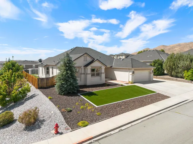 a view of a white house with a big yard and large trees