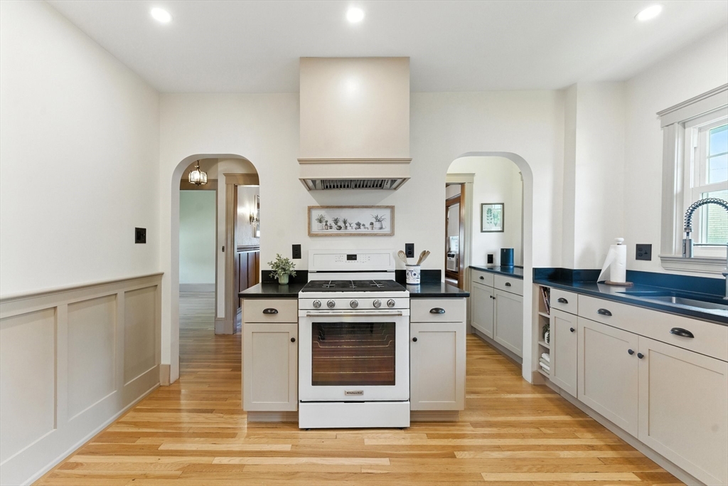 29 Hillcrest Circle, Unit 2 Watertown, MA 02472 - Photo 13 of 36 a kitchen with stainless steel appliances granite countertop a stove and white cabinets