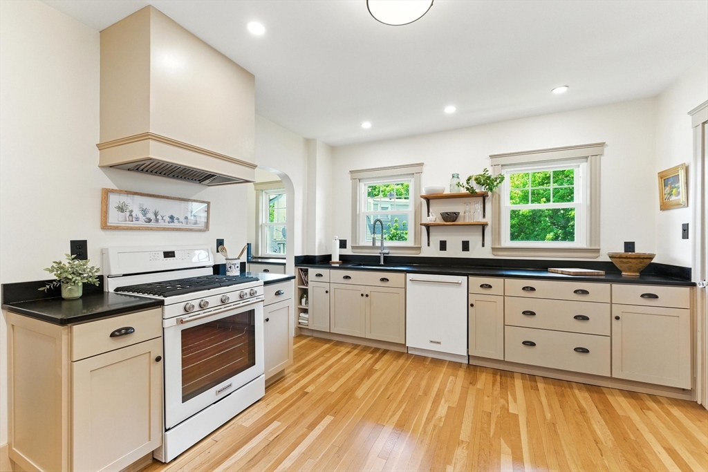 29 Hillcrest Circle, Unit 2 Watertown, MA 02472 - Photo 14 of 36 a kitchen with granite countertop a stove sink and cabinets