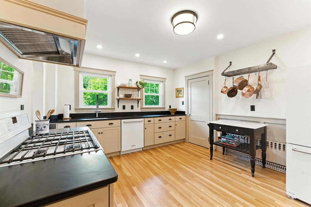 29 Hillcrest Circle, Unit 2 Watertown, MA 02472 - Photo 15 of 36 a kitchen with a stove a sink and a dining table
