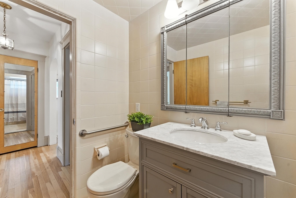 29 Hillcrest Circle, Unit 2 Watertown, MA 02472 - Photo 18 of 36 a bathroom with a granite countertop sink toilet and shower