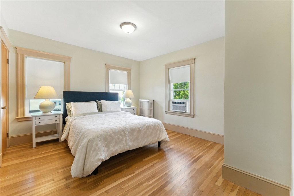 29 Hillcrest Circle, Unit 2 Watertown, MA 02472 - Photo 19 of 36 a bedroom with a bed wooden floor and window