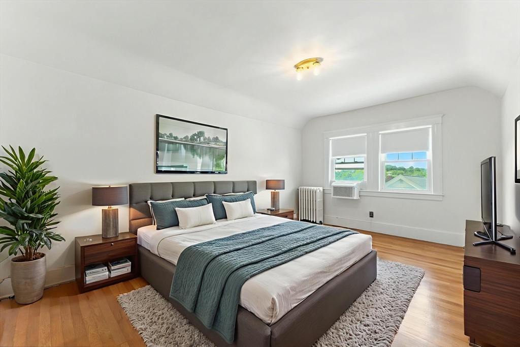 29 Hillcrest Circle, Unit 2 Watertown, MA 02472 - Photo 29 of 36 a bedroom with bed and a potted plant