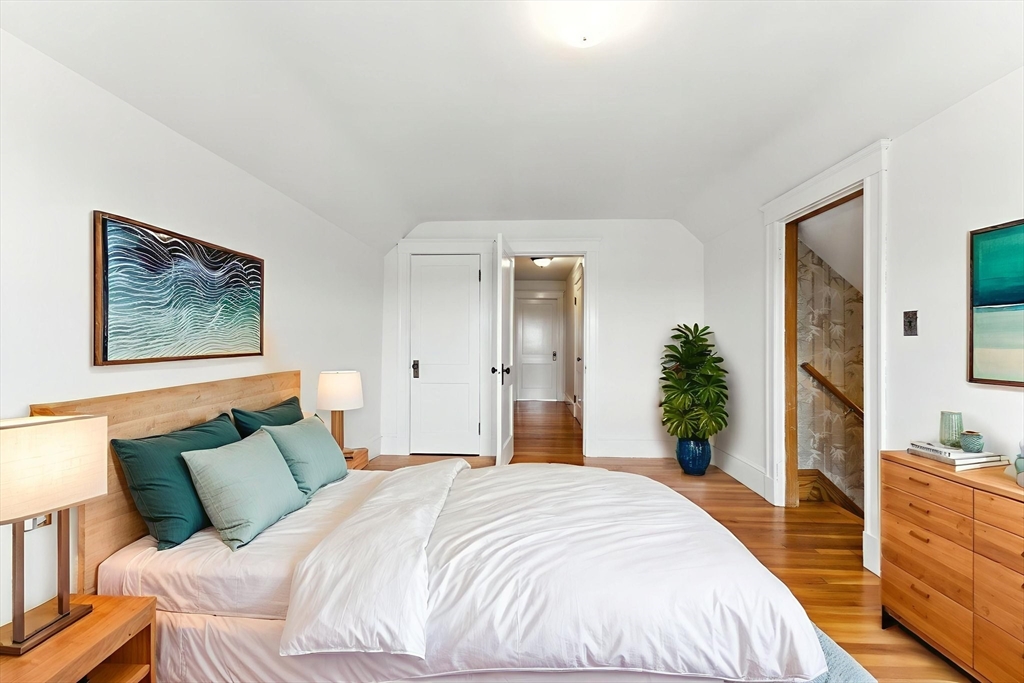 29 Hillcrest Circle, Unit 2 Watertown, MA 02472 - Photo 30 of 36 a spacious bedroom with a bed and a large mirror