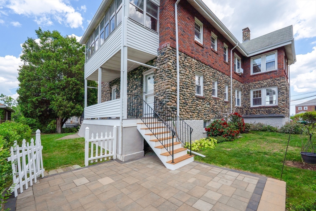 29 Hillcrest Circle, Unit 2 Watertown, MA 02472 - Photo 33 of 36 a view of a brick building with a yard