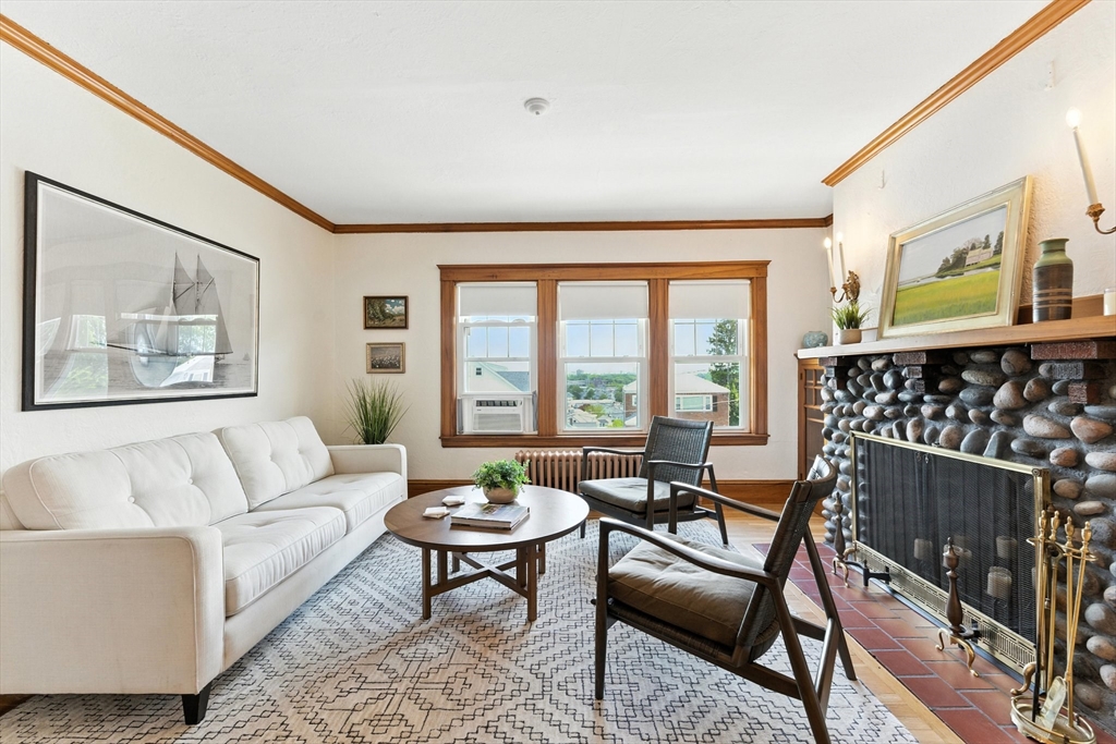 29 Hillcrest Circle, Unit 2 Watertown, MA 02472 - Photo 6 of 36 a living room with furniture and a floor to ceiling window
