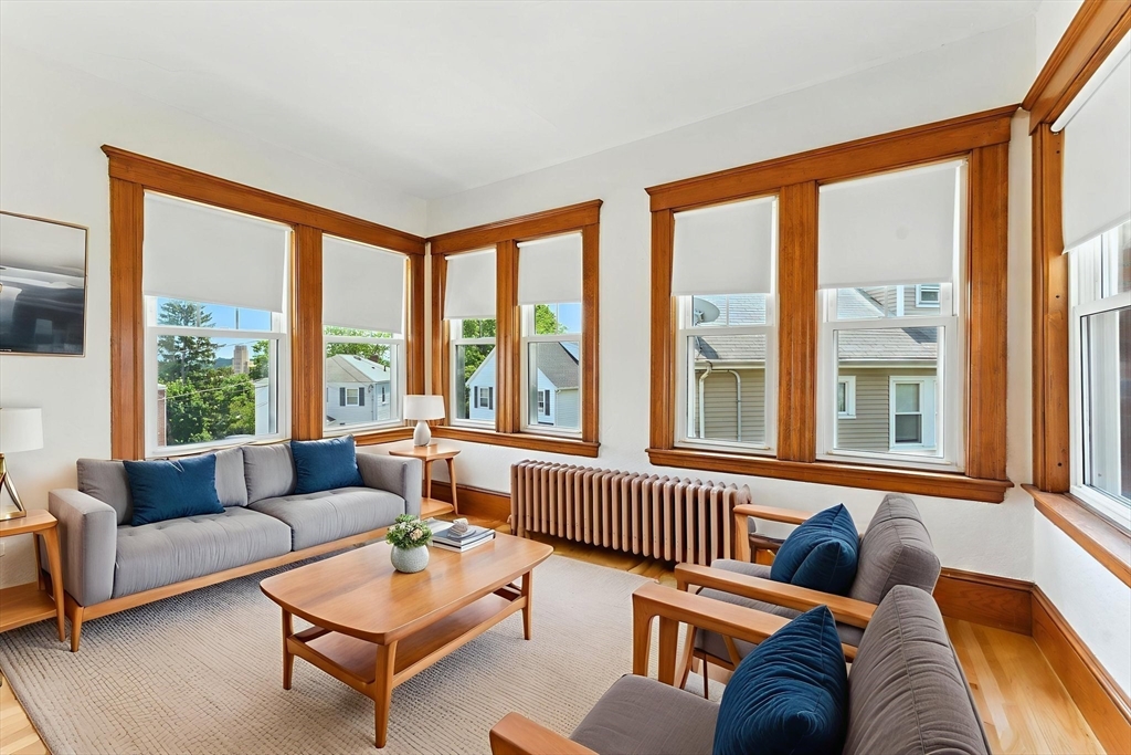 29 Hillcrest Circle, Unit 2 Watertown, MA 02472 - Photo 8 of 36 a living room with furniture and a large window