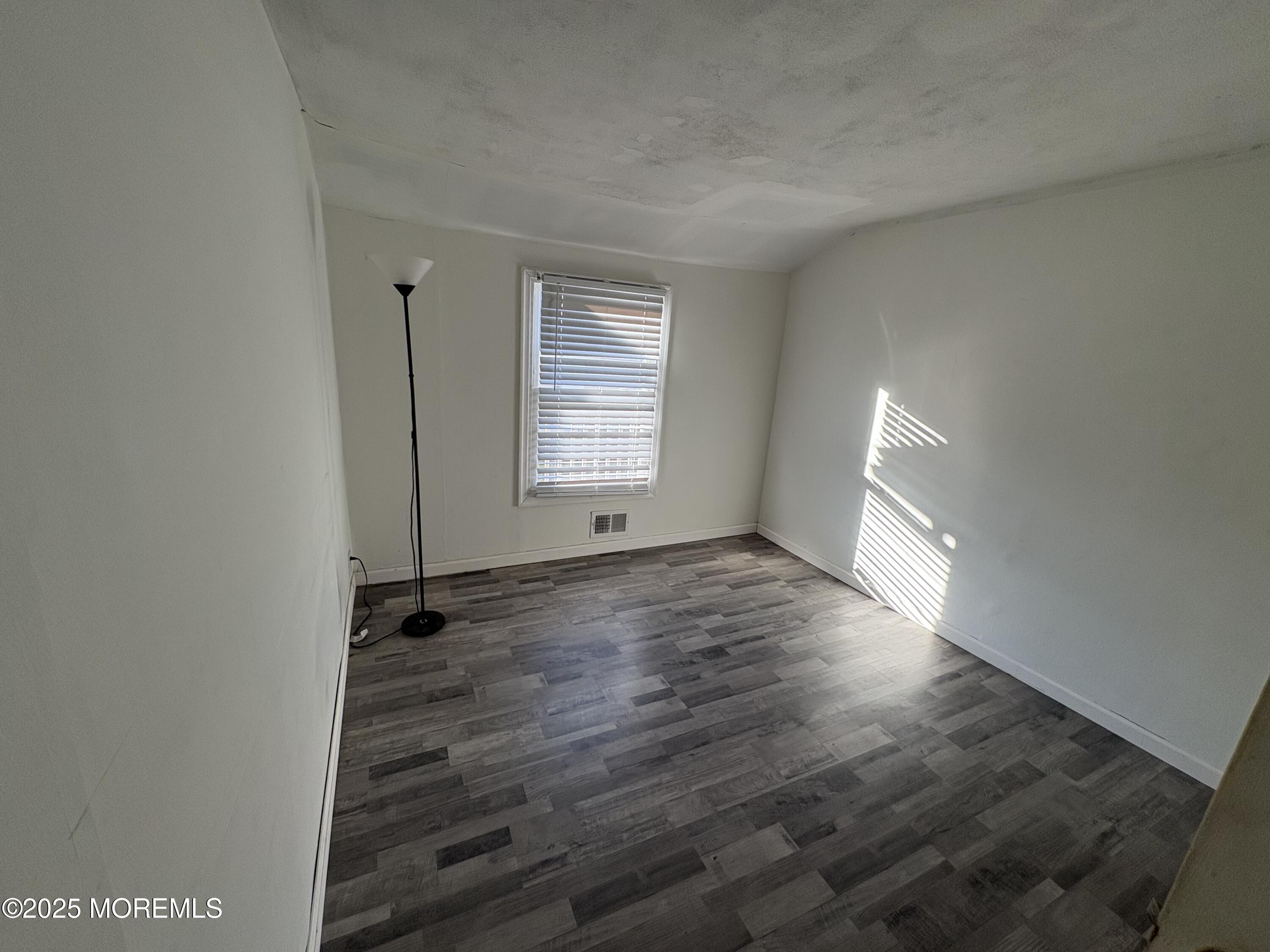 276 Linden Avenue North Middletown, NJ 07748 - Photo 11 of 15 an empty room with wooden floor and windows