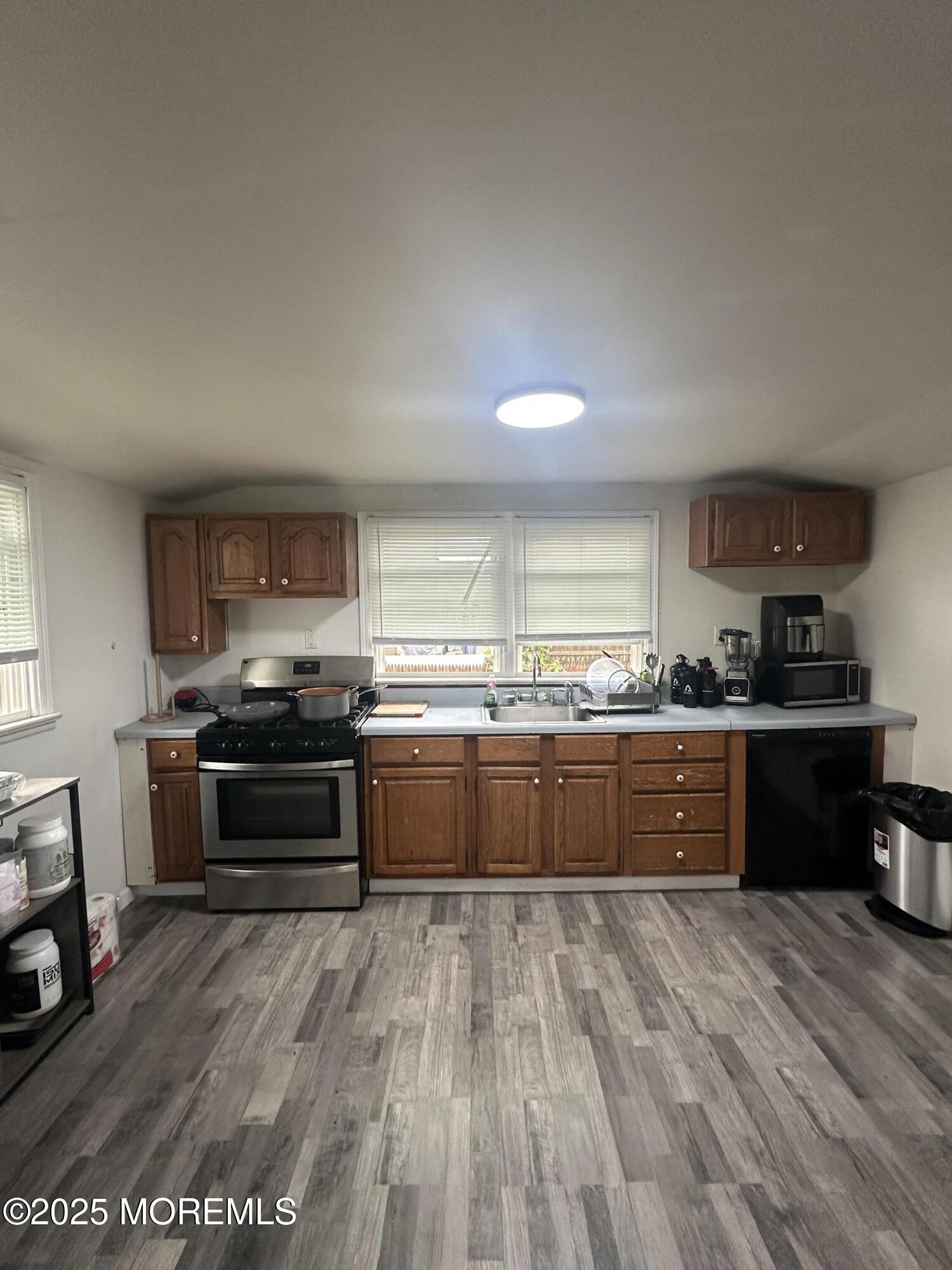 276 Linden Avenue North Middletown, NJ 07748 - Photo 2 of 15 a large kitchen with wooden floors and stainless steel appliances