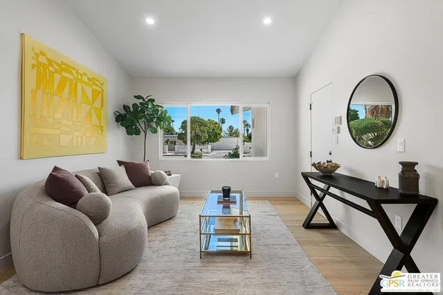 a view of a livingroom with furniture and a potted plant