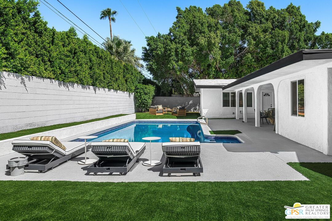 1433 North Fiesta Road Palm Springs, CA 92262 - Photo 27 of 30 a view of a backyard with table and chairs wooden floor and fence