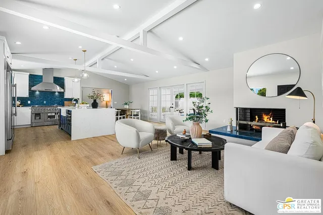 a living room with furniture and a mirror
