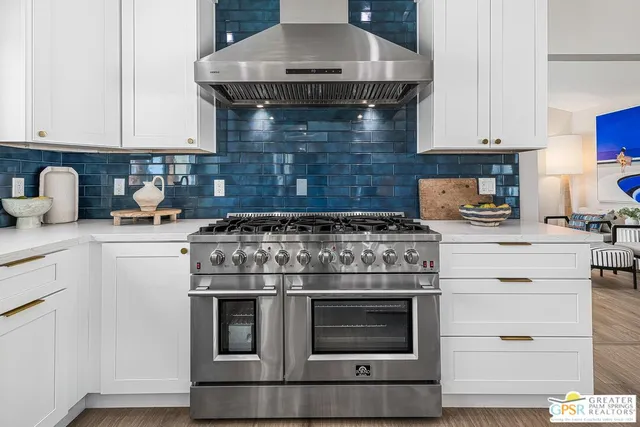 a kitchen with a stove a sink a refrigerator and a cabinets