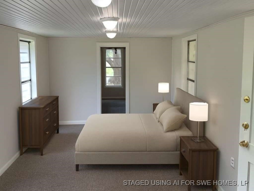 1329 Adams Road Bay City, TX 77414 - Photo 9 of 14 a bedroom with a bed and window with lamp