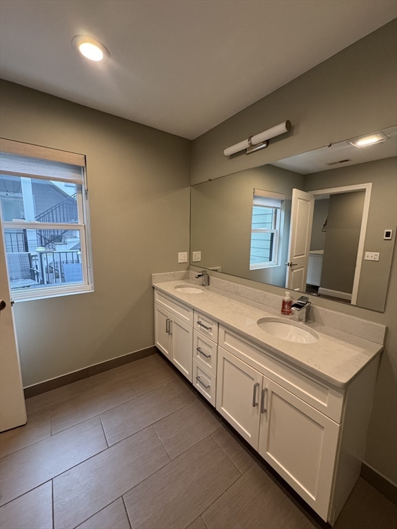 278 West Fifth Street, Unit 1 Boston, MA 02127 - Photo 11 of 22 a spacious bathroom with a double vanity sink and a mirror
