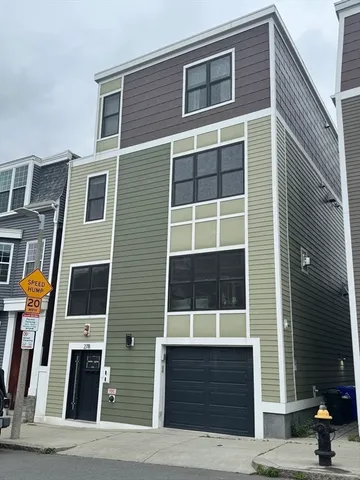 a front view of a house with a street