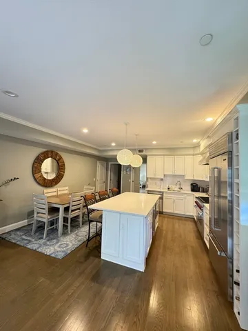 a large kitchen with a table and chairs in it
