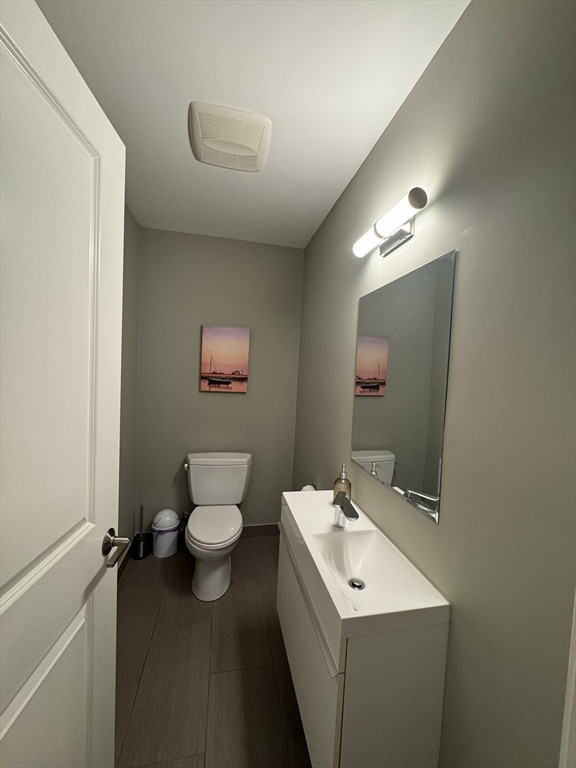 278 West Fifth Street, Unit 1 Boston, MA 02127 - Photo 7 of 22 a bathroom with a toilet sink and mirror