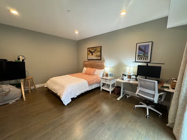 a bedroom with a bed and a chair