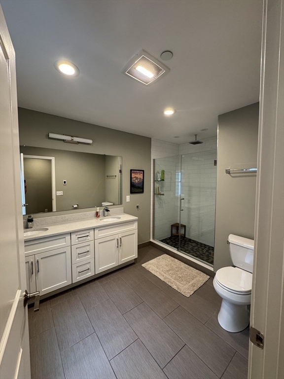 278 West Fifth Street, Unit 1 Boston, MA 02127 - Photo 10 of 22 a bathroom with a double vanity sink toilet mirror and bathtub