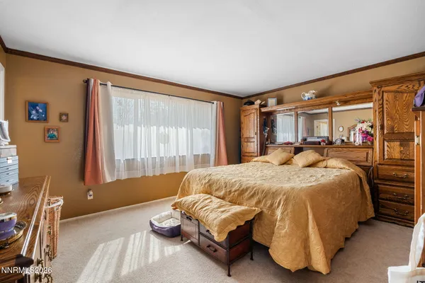 a spacious bedroom with a bed and window