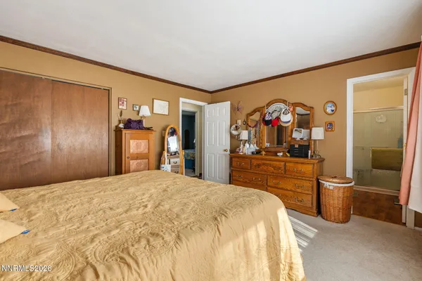 a bedroom with a large bed and a dresser