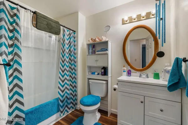 a bathroom with a sink toilet and a mirror