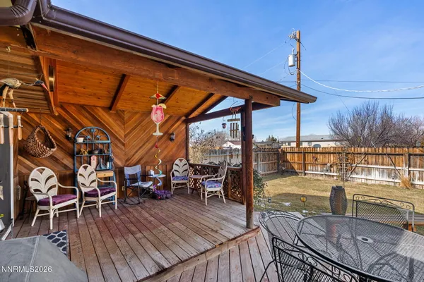 a view of a chairs and table on the deck
