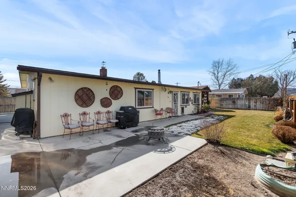 a view of a house with backyard and sitting area