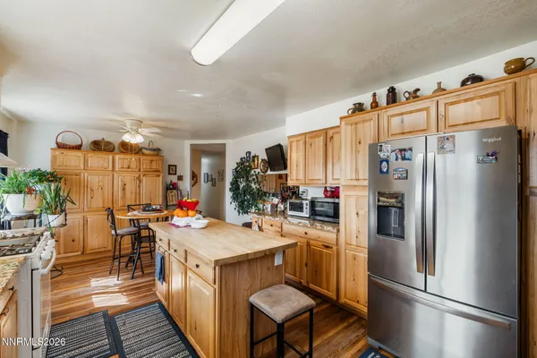 a kitchen with stainless steel appliances a refrigerator sink and cabinets