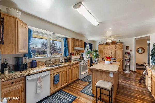 a kitchen with a sink stove and wooden cabinets