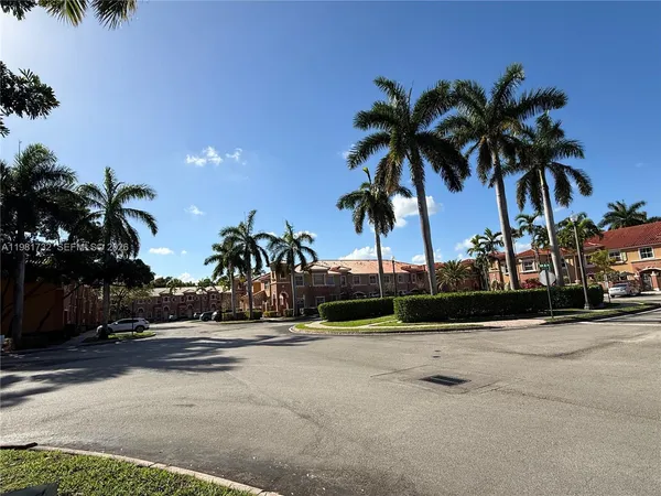 a view of street with palm trees