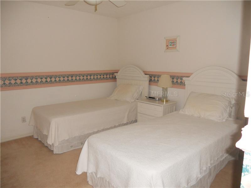 8911 Veranda Way, Unit 222 Sarasota, FL 34238 - Photo 12 of 25 a bedroom with a bed and a night stand