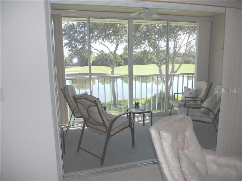 8911 Veranda Way, Unit 222 Sarasota, FL 34238 - Photo 13 of 25 a balcony with chairs and a table