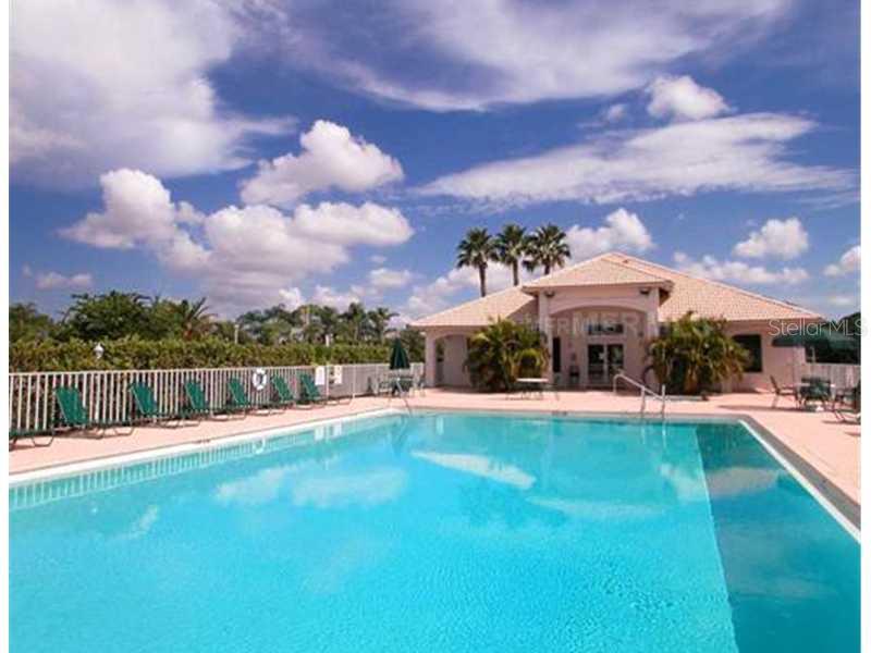 8911 Veranda Way, Unit 222 Sarasota, FL 34238 - Photo 20 of 25 a view of a house with swimming pool and a yard