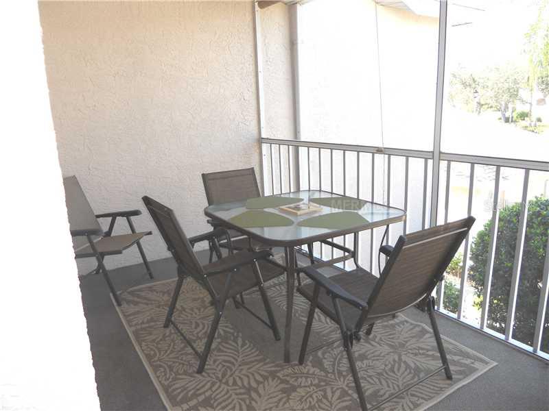 8911 Veranda Way, Unit 222 Sarasota, FL 34238 - Photo 2 of 25 a view of a dining room with furniture and wooden floor