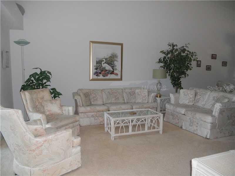 8911 Veranda Way, Unit 222 Sarasota, FL 34238 - Photo 6 of 25 a living room with furniture and a potted plant