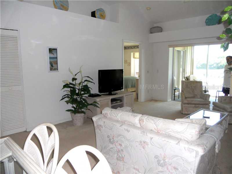 8911 Veranda Way, Unit 222 Sarasota, FL 34238 - Photo 7 of 25 a bedroom with a bed and a flat screen tv