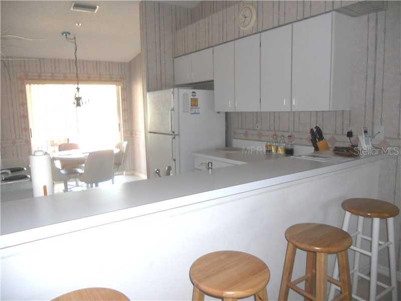 8911 Veranda Way, Unit 222 Sarasota, FL 34238 - Photo 9 of 25 a kitchen with a sink cabinets and window