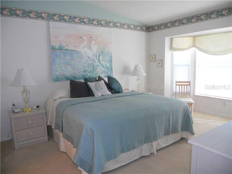 8911 Veranda Way, Unit 222 Sarasota, FL 34238 - Photo 10 of 25 a bedroom with a bed and a window