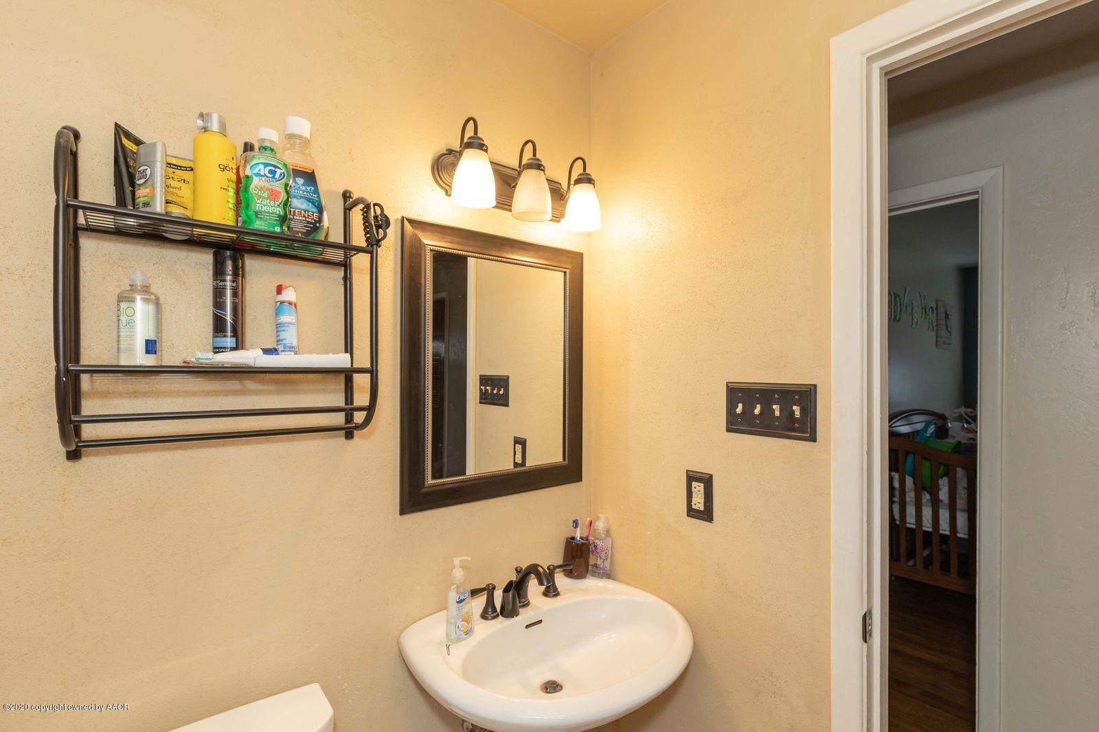4701 South Milam Street Amarillo, TX 79110 - Photo 26 of 32 a bathroom with a sink vanity and mirror