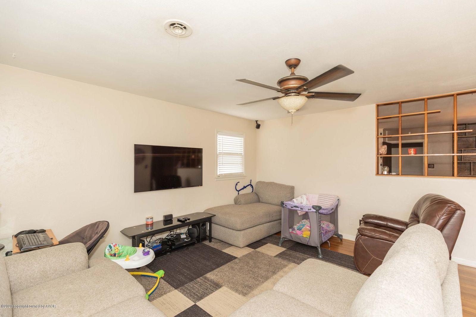 4701 South Milam Street Amarillo, TX 79110 - Photo 7 of 32 a living room with furniture and a flat screen tv