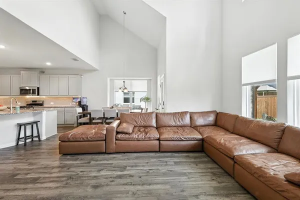 a living room with furniture white walls and wooden floor