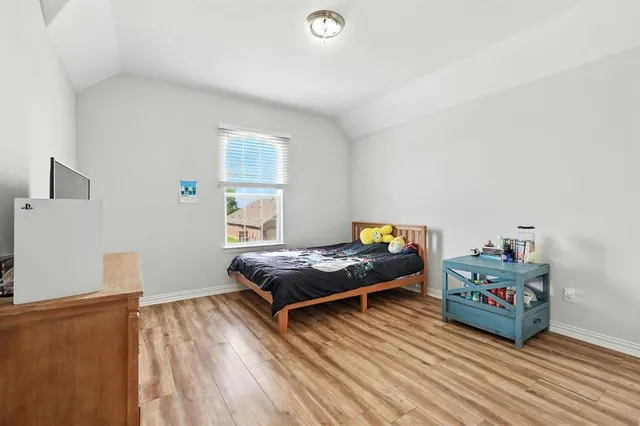 a bedroom with furniture and a wooden floor