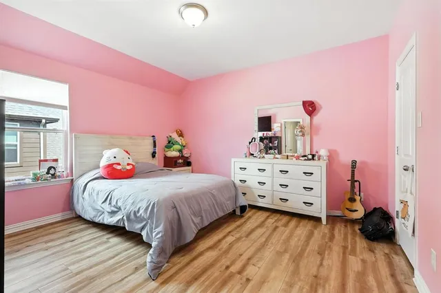 a bedroom with a bed and a dresser