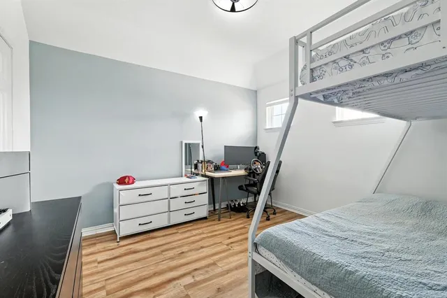 a bedroom with furniture and wooden floor